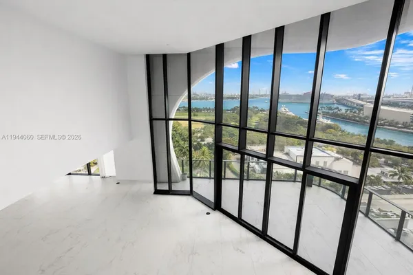 a view of an empty room with floor to ceiling window
