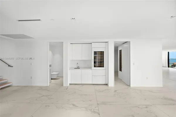 a kitchen with granite countertop a sink and a refrigerator
