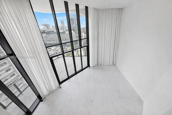 a view of an empty room with closet