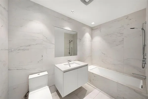 a bathroom with a bathtub and shower