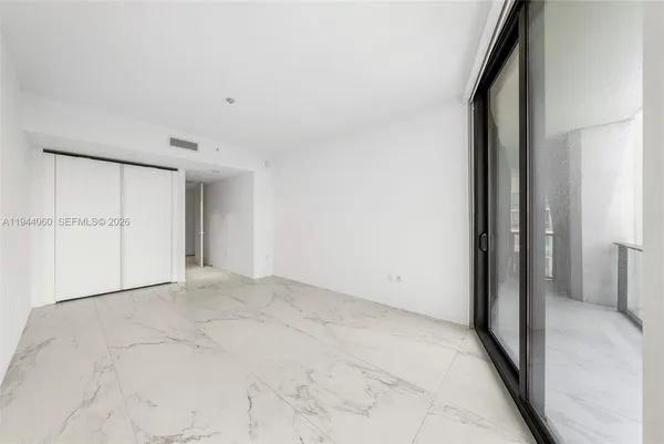 a view of an empty room with a window