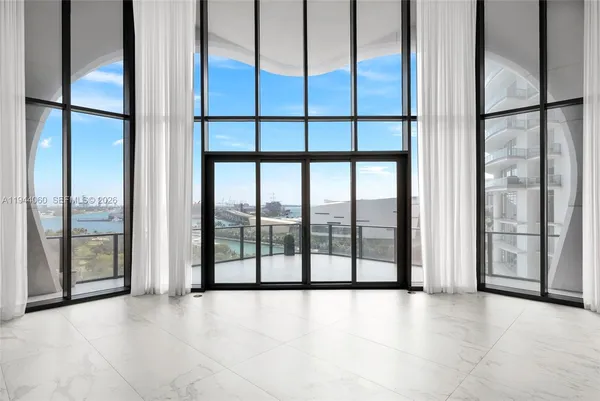 a view of empty room with floor to ceiling window