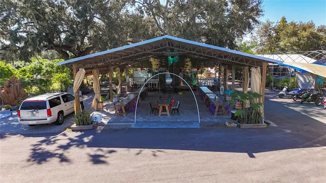 an outdoor space with lots of furniture and glass windows
