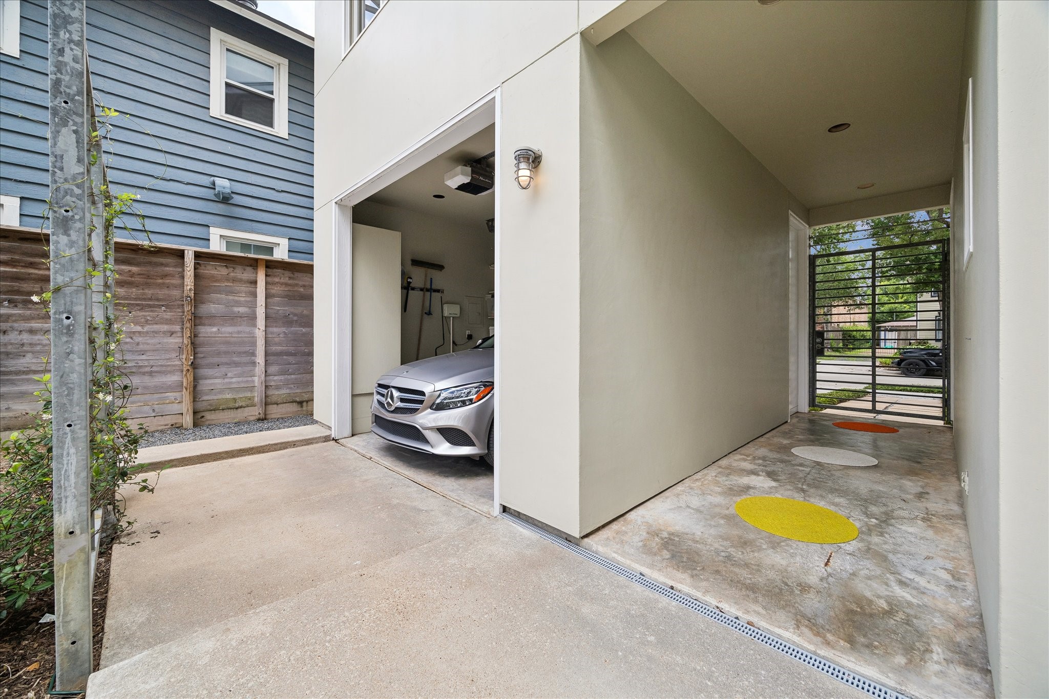 1418 Kipling Street Houston, TX 77006 - Photo 27 of 42 The one car garage and the breezeway to the entrance of the front building shown here. The view into the home from the private front gate shows a site line only of the residence across the courtyard. The pool is not very visible from this vantage point.