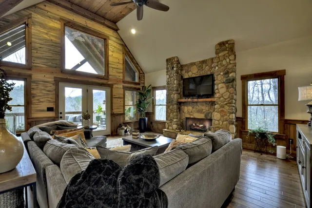 a living room with furniture a fireplace and a flat screen tv