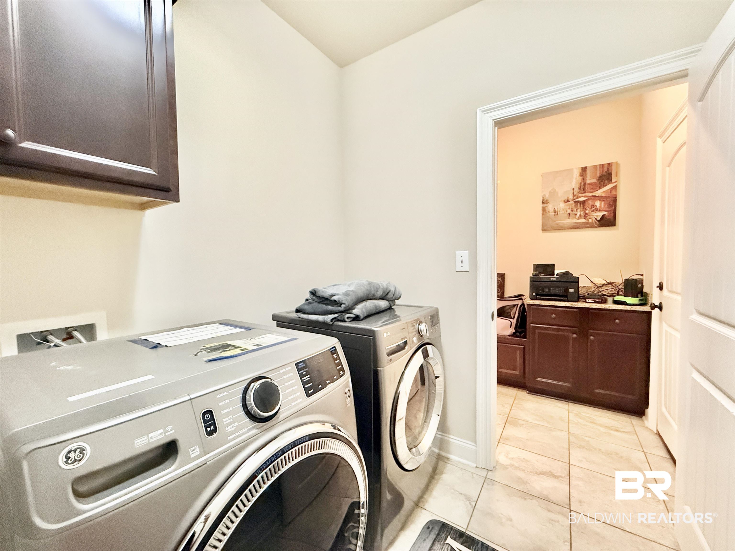7011 Rocky Rd Loop Gulf Shores, AL 36542 - Photo 19 of 66 Laundry room featuring light tile patterned floors, cabinet space, and washer and clothes dryer