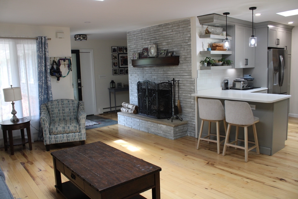 225 Braemoor Road Brockton, MA 02301 - Photo 29 of 29 a living room with furniture a table and kitchen view