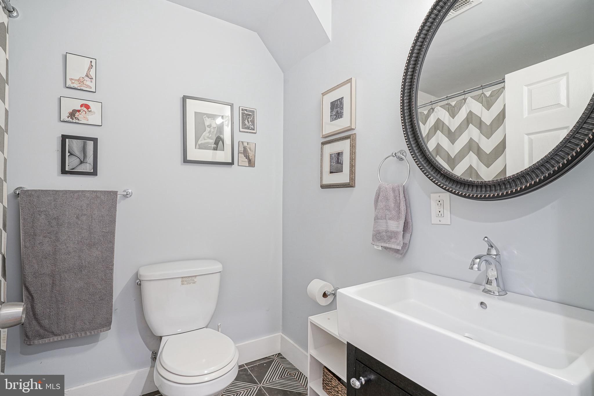 2111 Manton Street Philadelphia, PA 19146 - Photo 19 of 37 a bathroom with a toilet a sink and a mirror