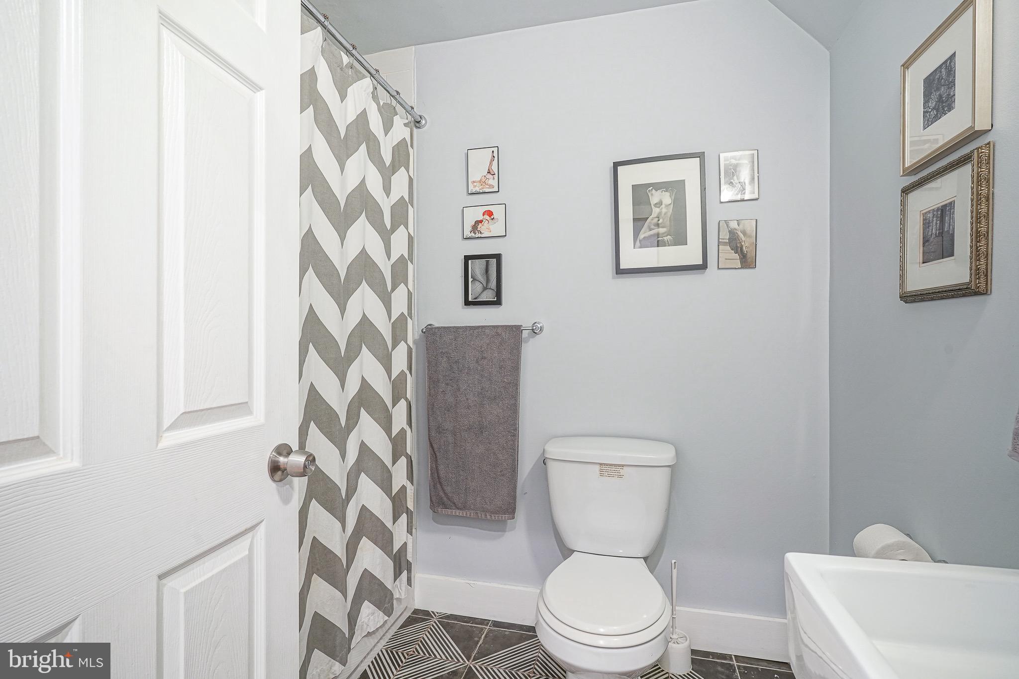 2111 Manton Street Philadelphia, PA 19146 - Photo 20 of 37 a white toilet sitting next to a shower curtain