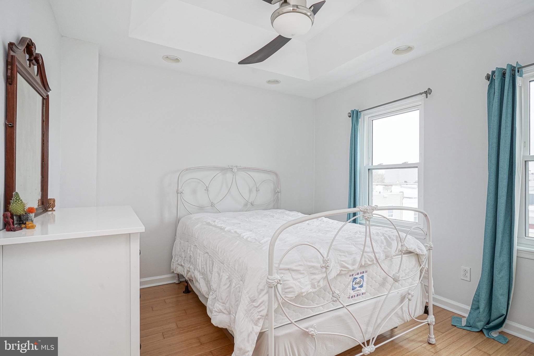 2111 Manton Street Philadelphia, PA 19146 - Photo 26 of 37 a bedroom with a bed and a flat tv screen on the dresser