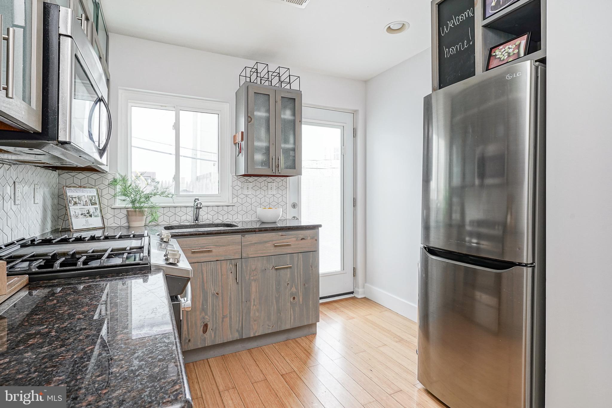 2111 Manton Street Philadelphia, PA 19146 - Photo 8 of 37 a kitchen with granite countertop a refrigerator stove and sink