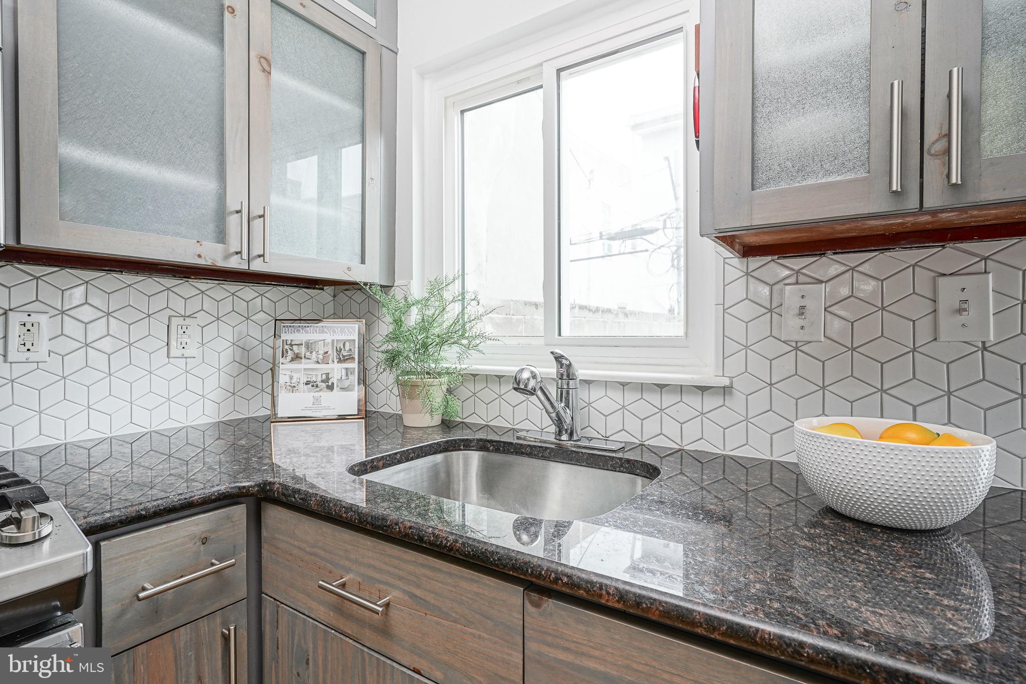 2111 Manton Street Philadelphia, PA 19146 - Photo 9 of 37 a kitchen with granite countertop a sink and a white wooden cabinets