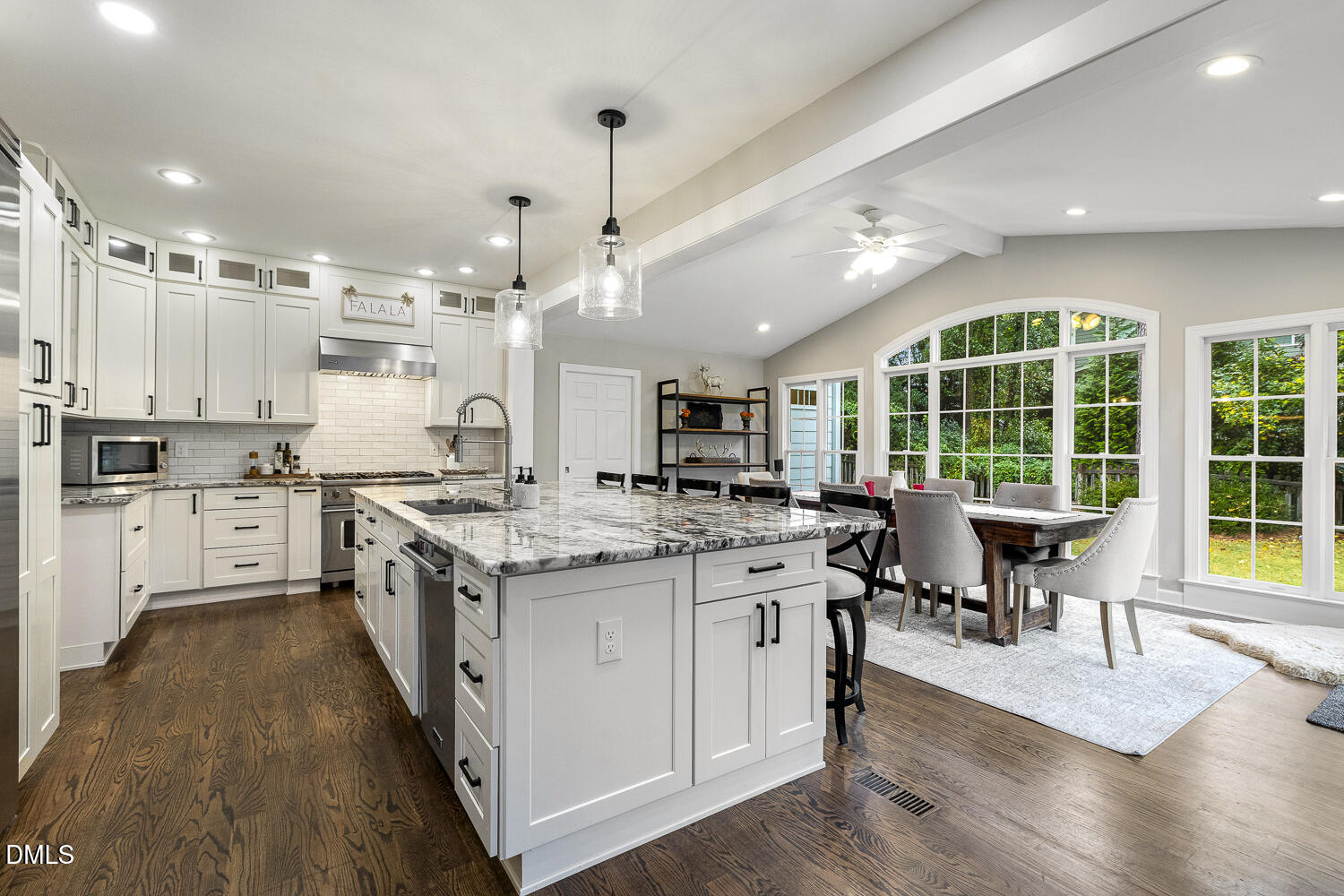 a kitchen with stainless steel appliances granite countertop a stove and cabinets