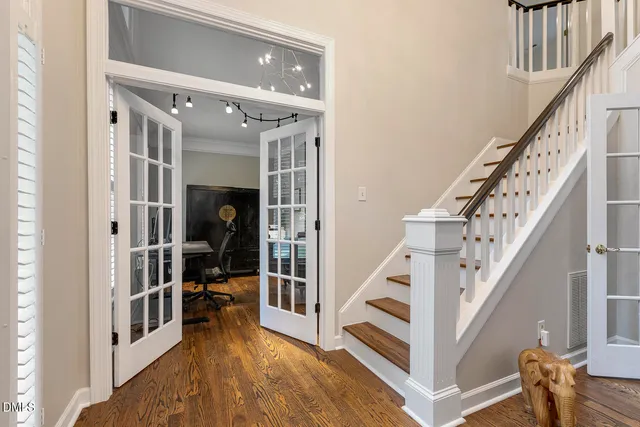 a view of a workspace with furniture and wooden floor