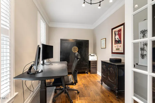 a living room with furniture a fireplace and a large window