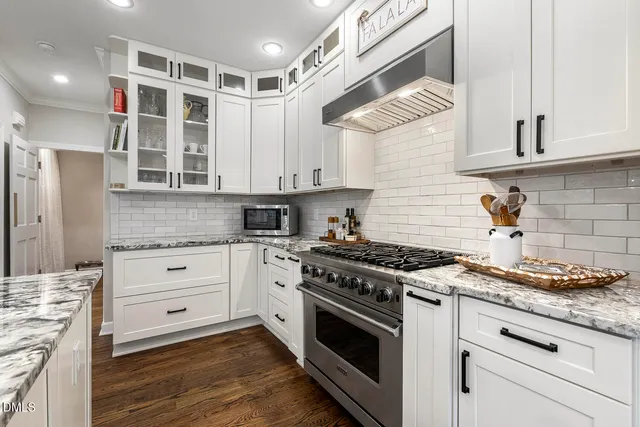 a view of a kitchen with a sink and wooden floor