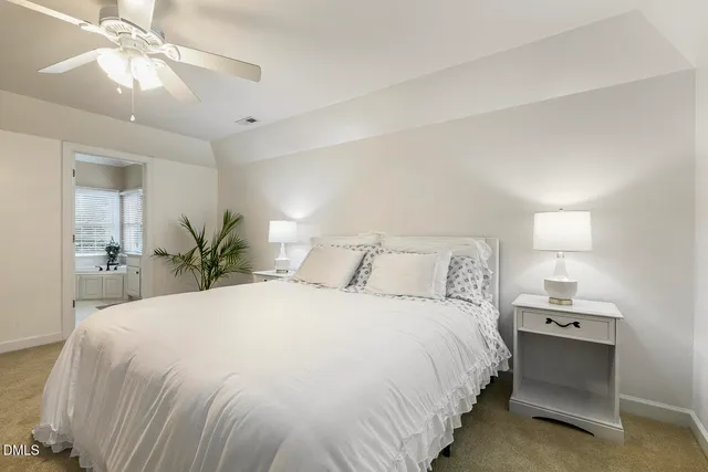 a bedroom with bed couches and window