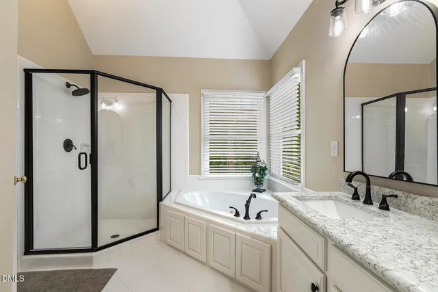 a bathroom with a double vanity sink a two mirror and a bathtub