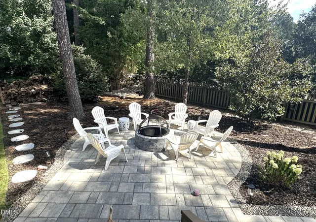 a view of a patio with table and chairs and potted plants
