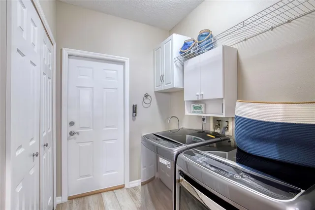 a view of a bedroom with furniture and wooden floor