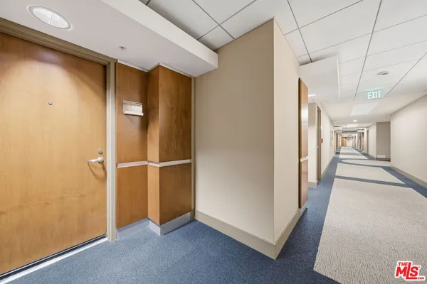 a bedroom with a bed and a large mirror
