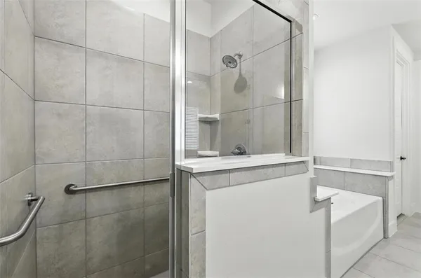 a bathroom with a shower and a sink