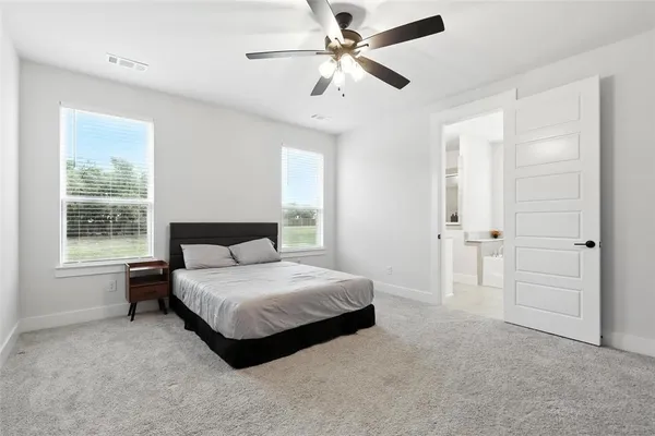 a spacious bedroom with a bed and a window