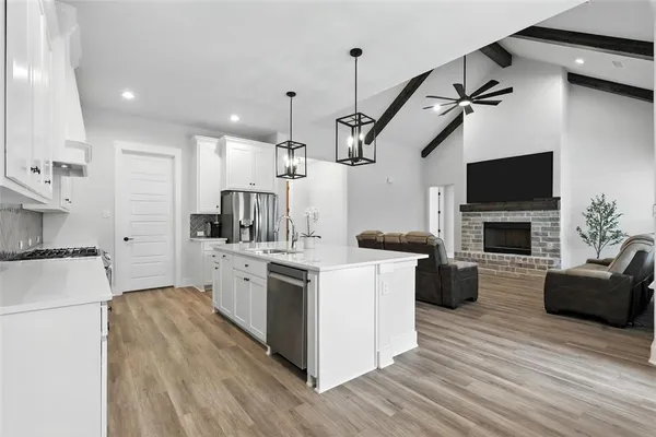 a kitchen with a stove a sink and a refrigerator