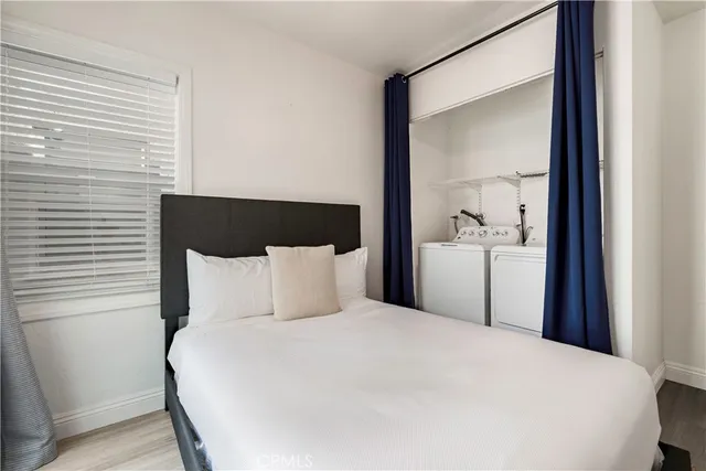 a large bed in a bedroom next to a window