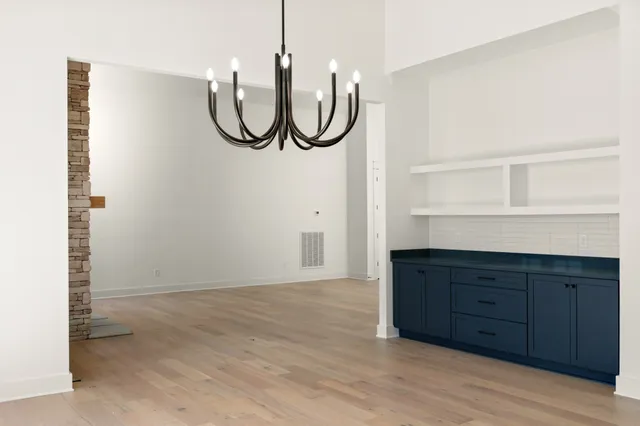 a room with wooden floor and white walls