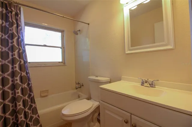 a bathroom with a sink a toilet and a shower