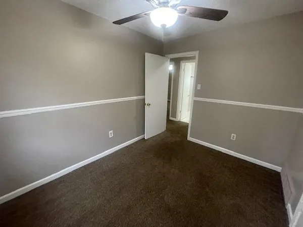 an empty room with a empty space and a ceiling fan