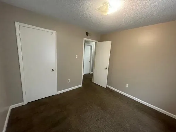 an empty room with closet area