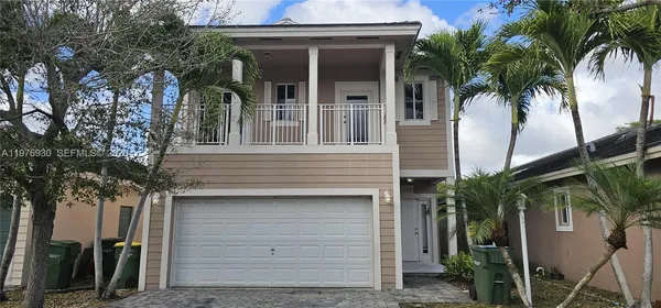 a view of a house with a tree