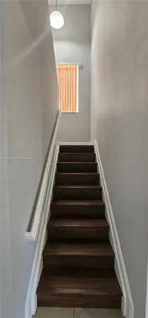 a bathroom with a toilet a sink and a mirror