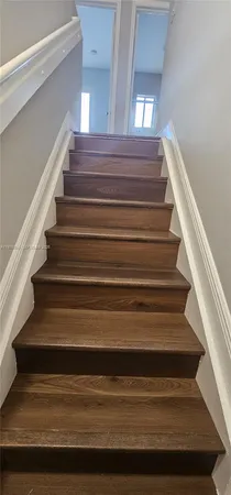 a bathroom with a toilet a sink and shower