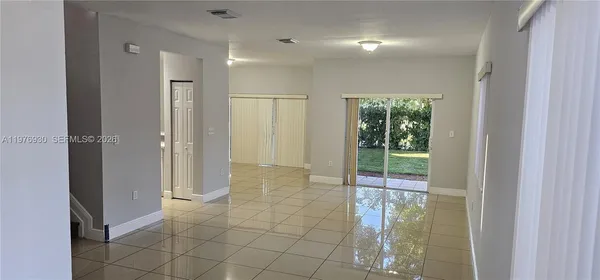 an empty room that has a glass door