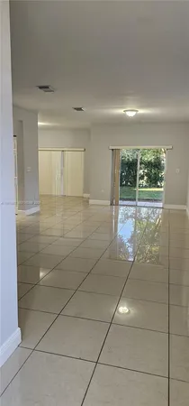 a kitchen with a sink a microwave a refrigerator and cabinets