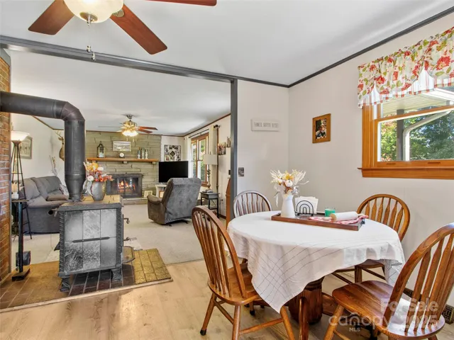 a dining room with furniture and wooden floor