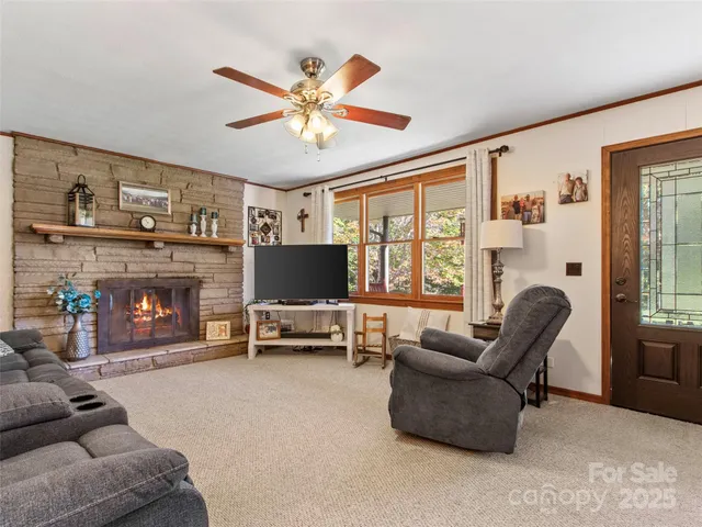 a living room with furniture a fireplace and a flat screen tv