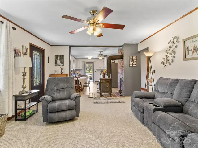 a living room with furniture and a chandelier