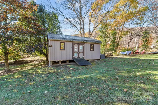 a view of backyard with house and outdoor seating