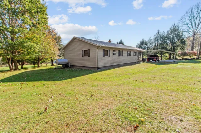 a front view of house with yard and trees