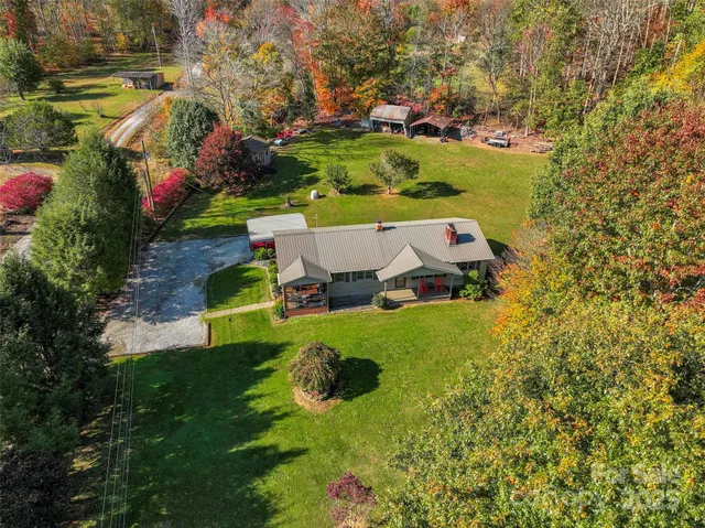 an aerial view of a house with a yard basket ball court and outdoor seating