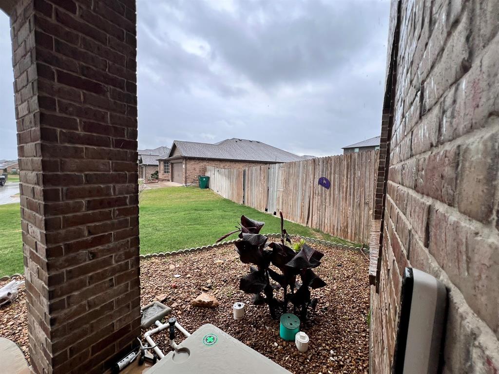 324 Fairgrounds Lane Ponder, TX 76259 - Photo 38 of 40 a view of a patio with table and chairs with wooden fence and plants