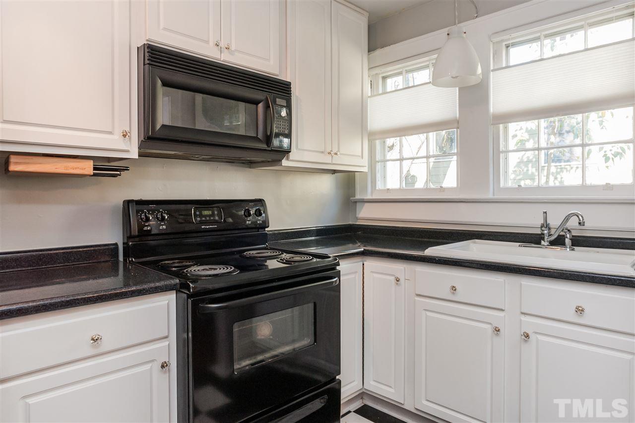 1507 Hanover Street Raleigh, NC 27608 - Photo 7 of 16 Clean white kitchen adds to the contemporary feel of the home.