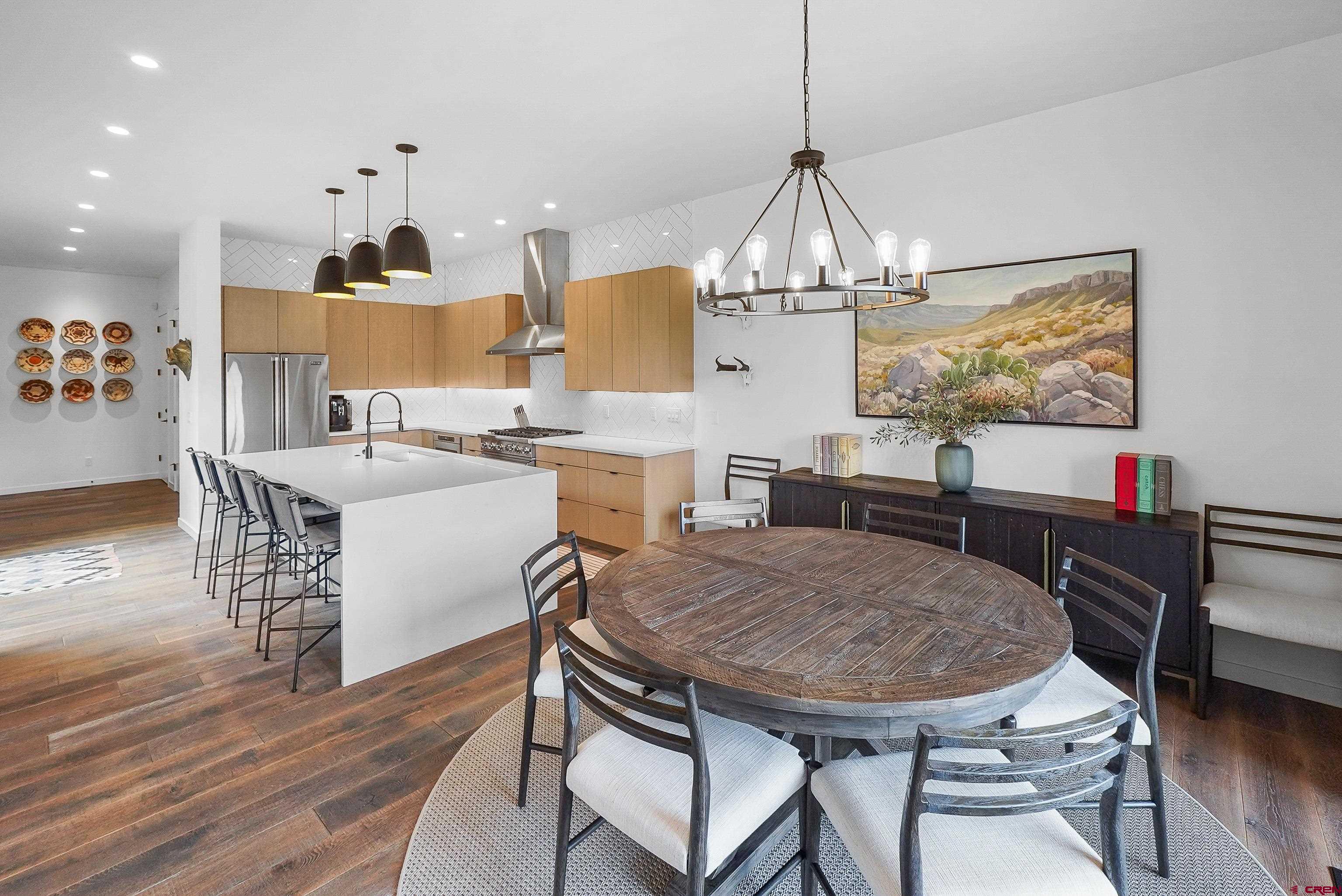 239 Rock Point Drive, Unit B Durango, CO 81301 - Photo 21 of 45 a view of a dining room with furniture wooden floor and chandelier