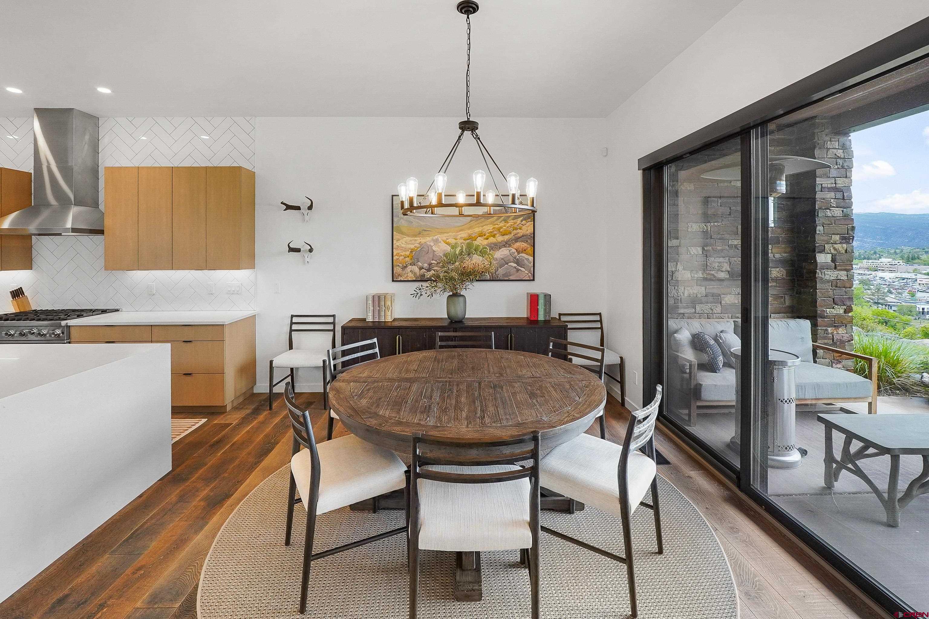 239 Rock Point Drive, Unit B Durango, CO 81301 - Photo 22 of 45 a dining room with furniture a chandelier and wooden floor