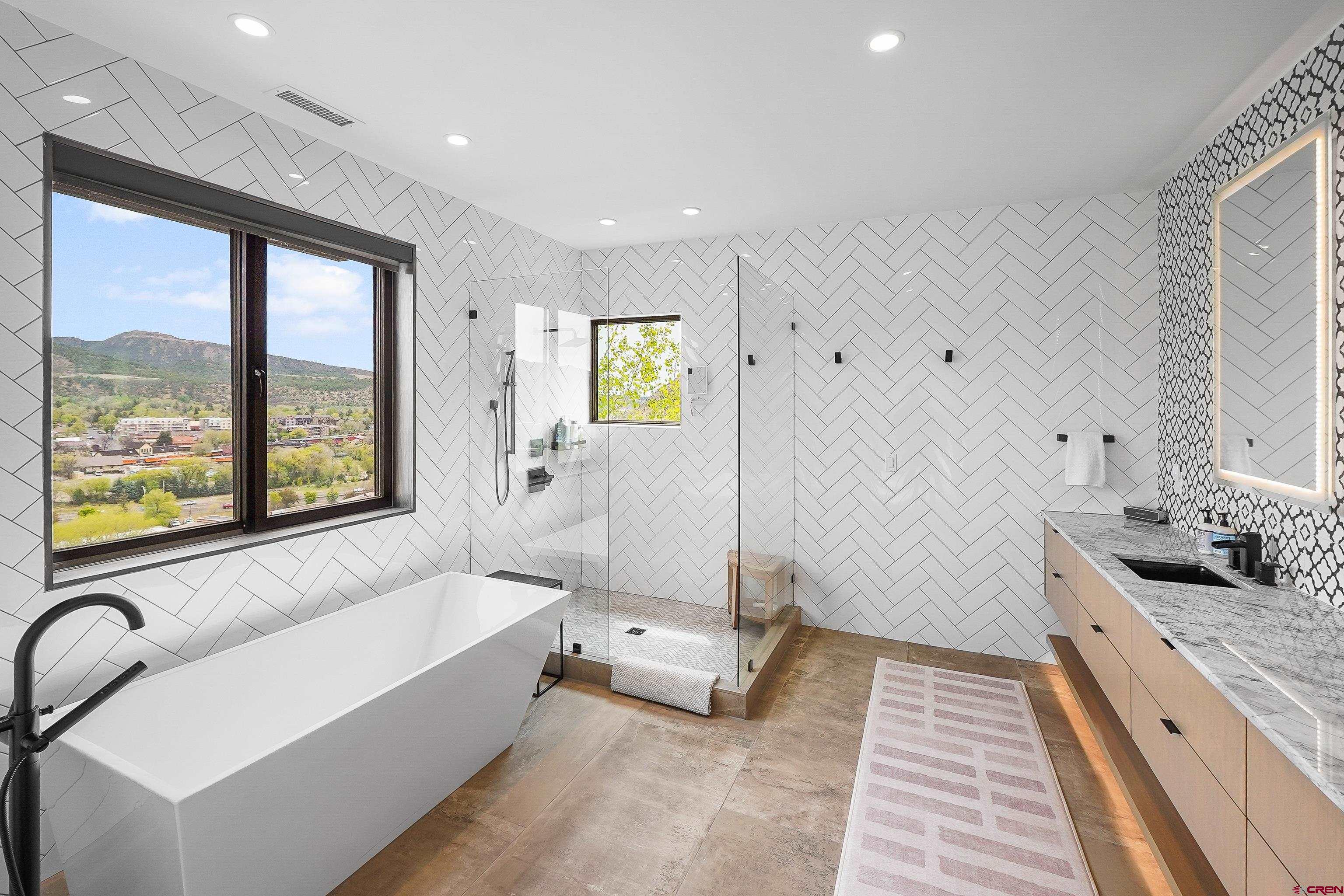 239 Rock Point Drive, Unit B Durango, CO 81301 - Photo 26 of 45 a bathroom with a granite countertop tub sink and mirror