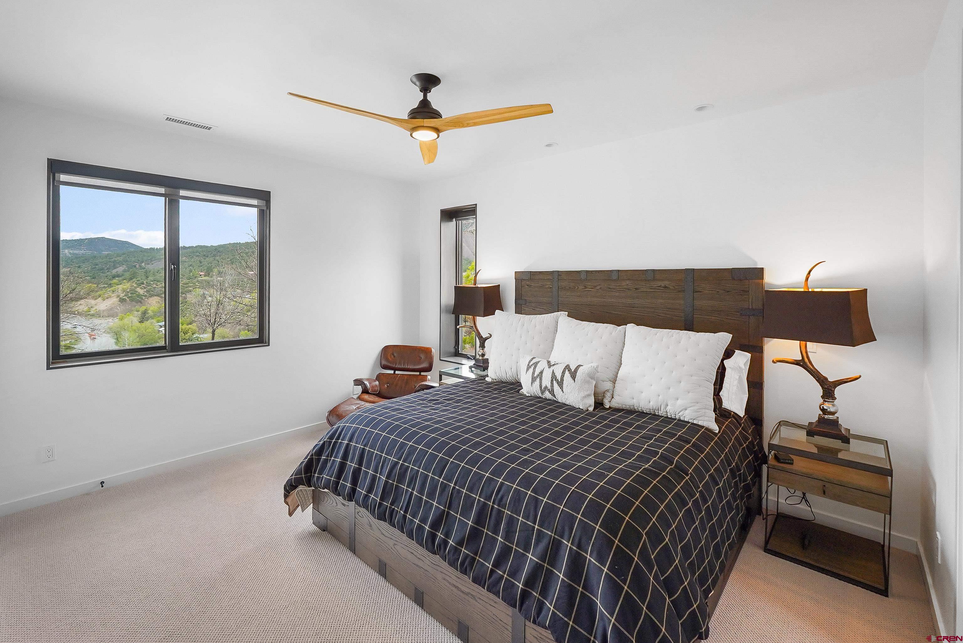 239 Rock Point Drive, Unit B Durango, CO 81301 - Photo 29 of 45 a bedroom with a bed and a painting on the wall